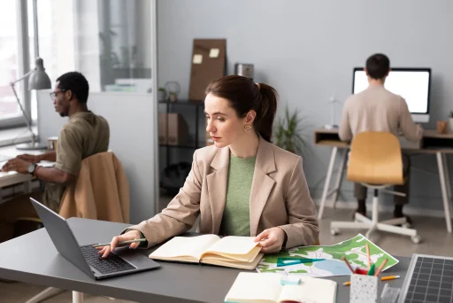 Student working on a laptop in an office setting