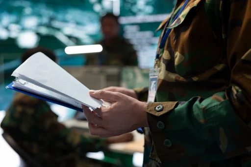 Service member holding a clipboard