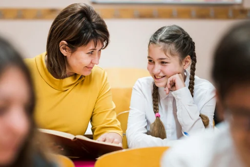 Teacher and student smiling together